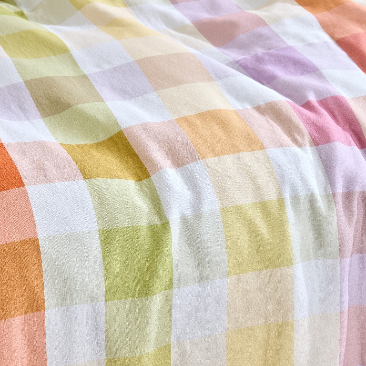 Close-up of a checkered fabric with pastel colors on a white background