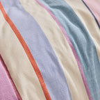 Close-up of fabric with multicolored stripes in pink, blue, orange, and beige.