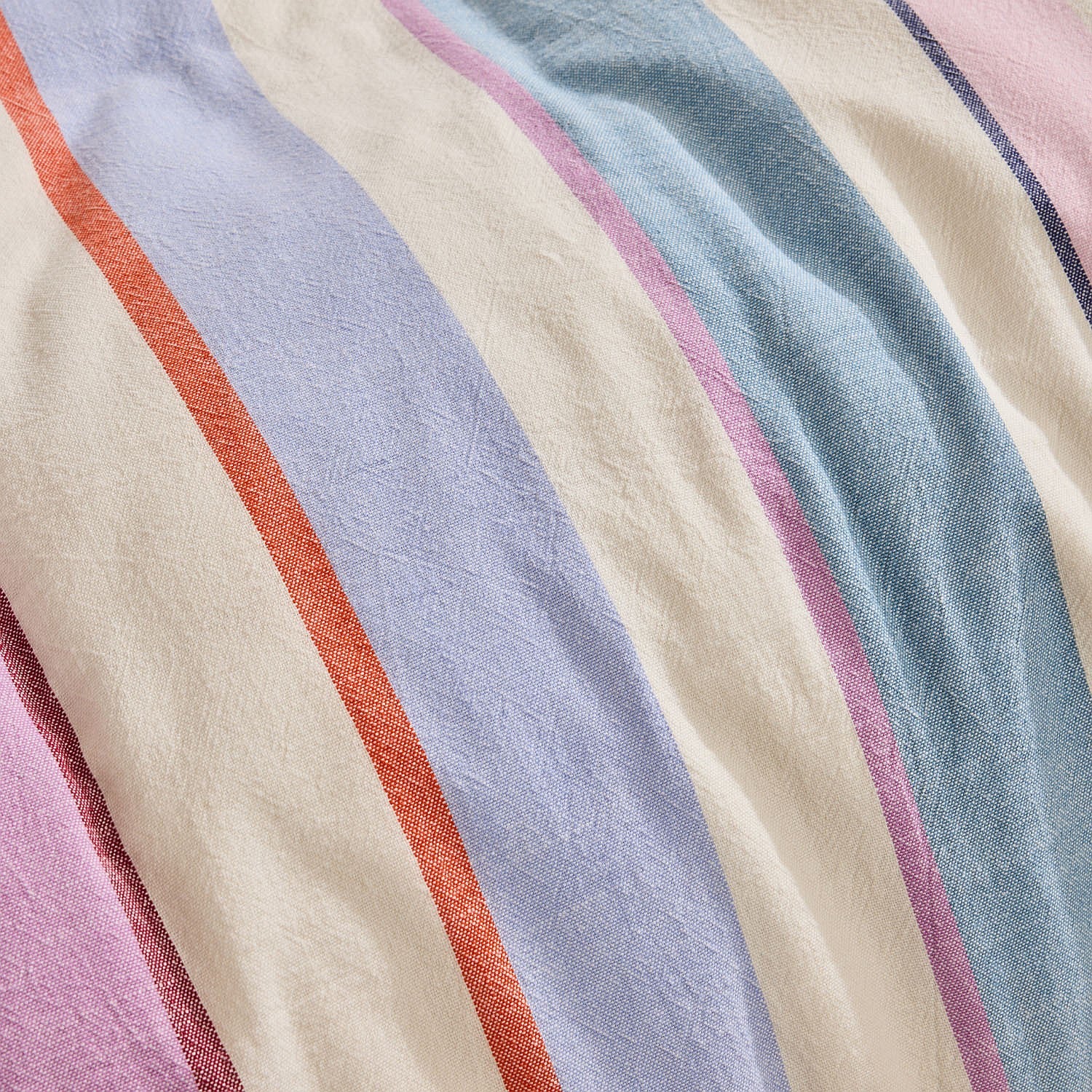 Close-up of fabric with multicolored stripes in pink, blue, orange, and beige.