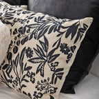 Floral patterned pillow with black design on beige background