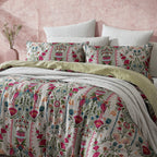 Floral bedding set on a bed with a pink textured wall in the background