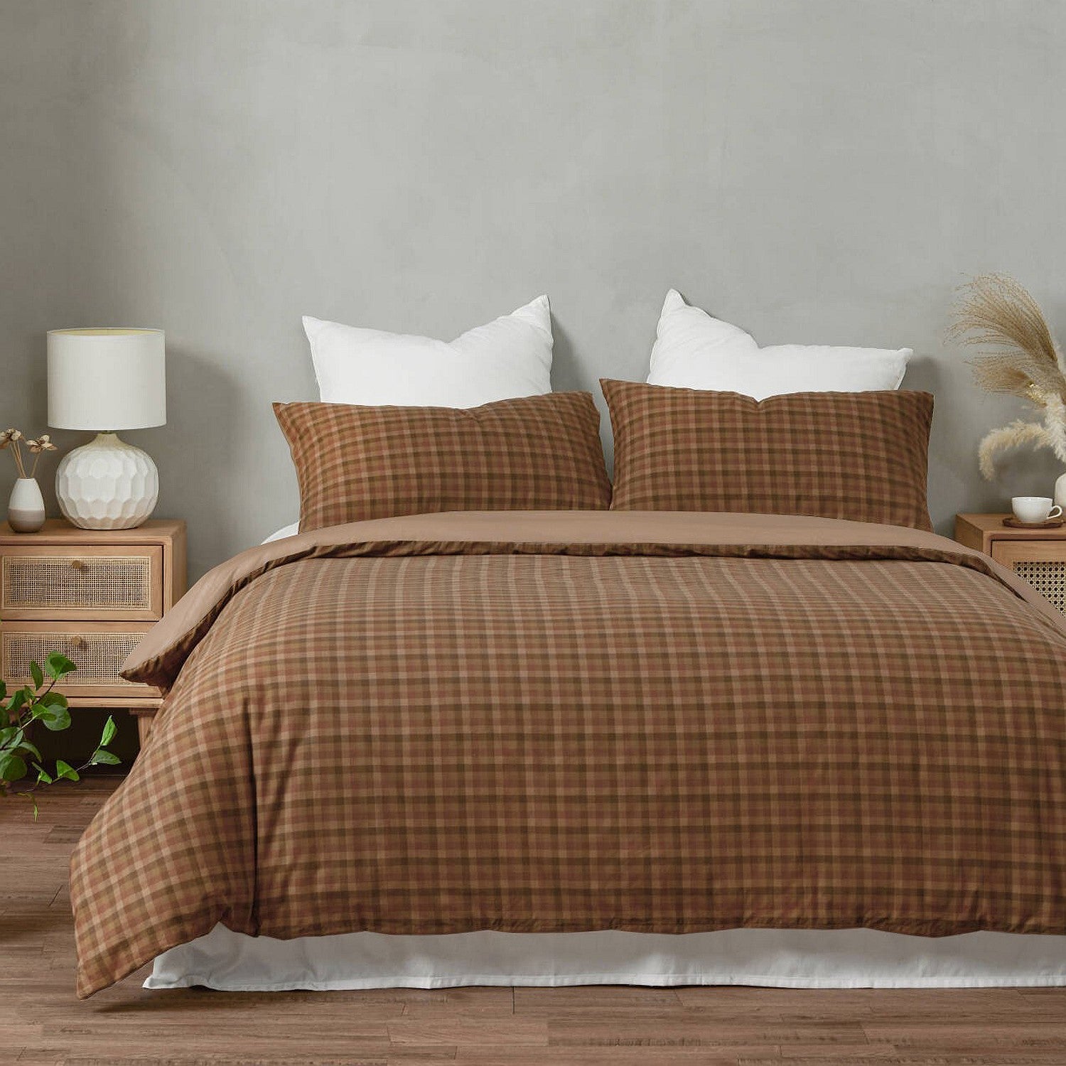 Brown checkered duvet set on a bed with white pillows in a bedroom setting.