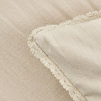 Close-up of a textured fabric with a soft, neutral color.