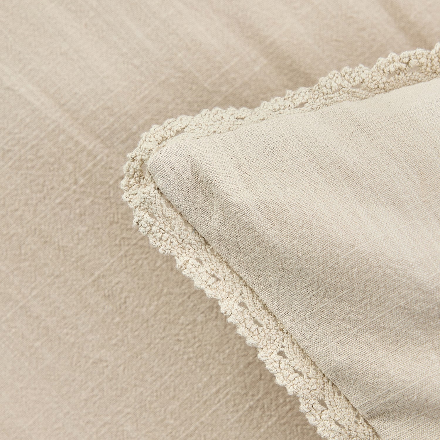 Close-up of a textured fabric with a soft, neutral color.