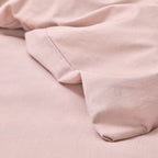 Close-up of soft pink fabric with a subtle texture