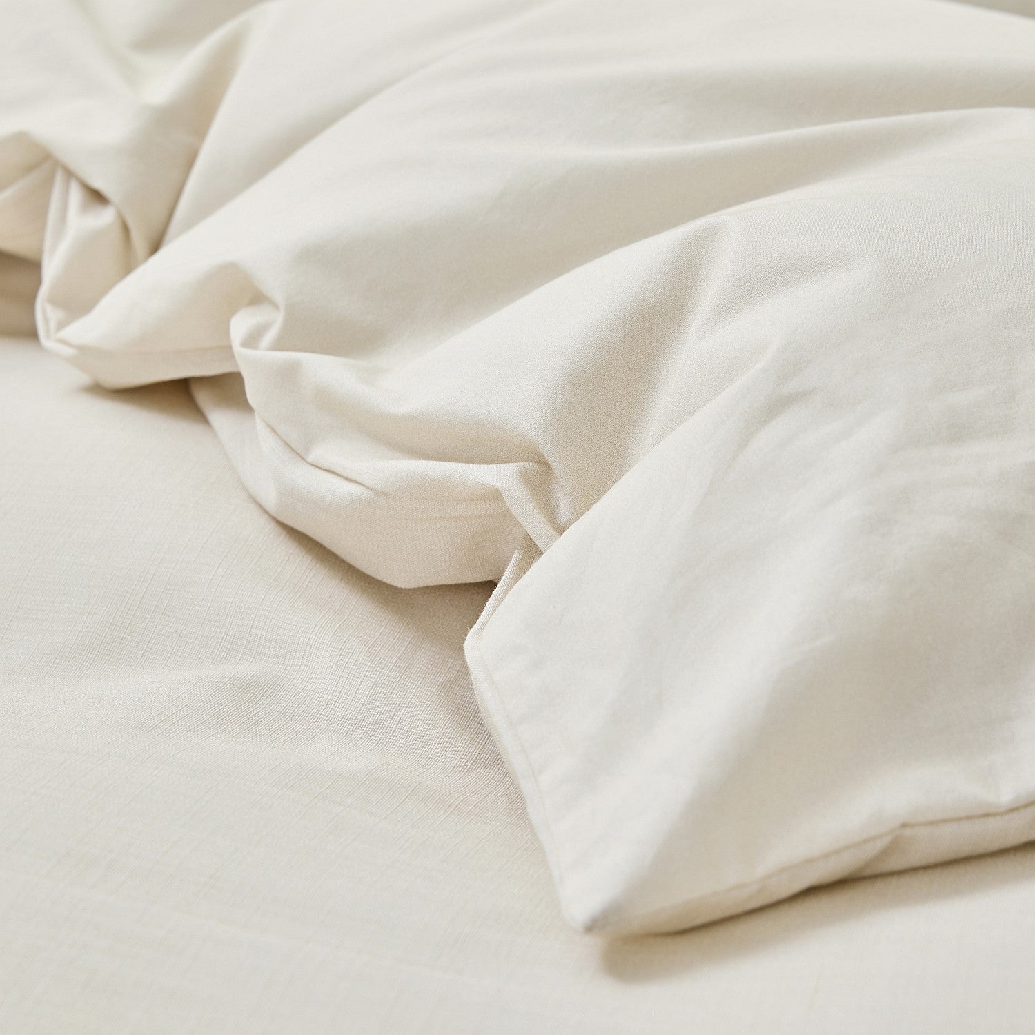 Close-up of beige comforter on a bed