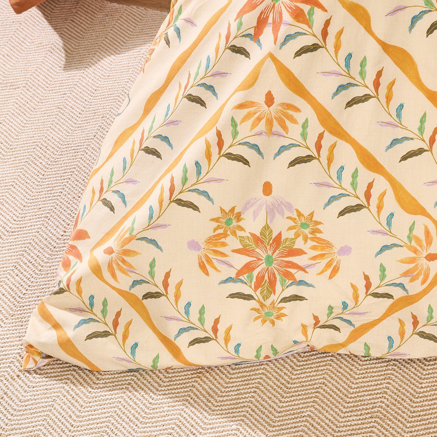Decorative pillow with floral pattern on a textured surface