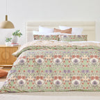 Floral patterned bedding set on a bed in a bedroom setting.