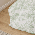 Floral-patterned bedskirt on a wooden floor