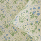 Floral patterned fabric with blue and green flowers on a beige background
