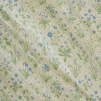 Patterned fabric with green and blue floral design on beige background