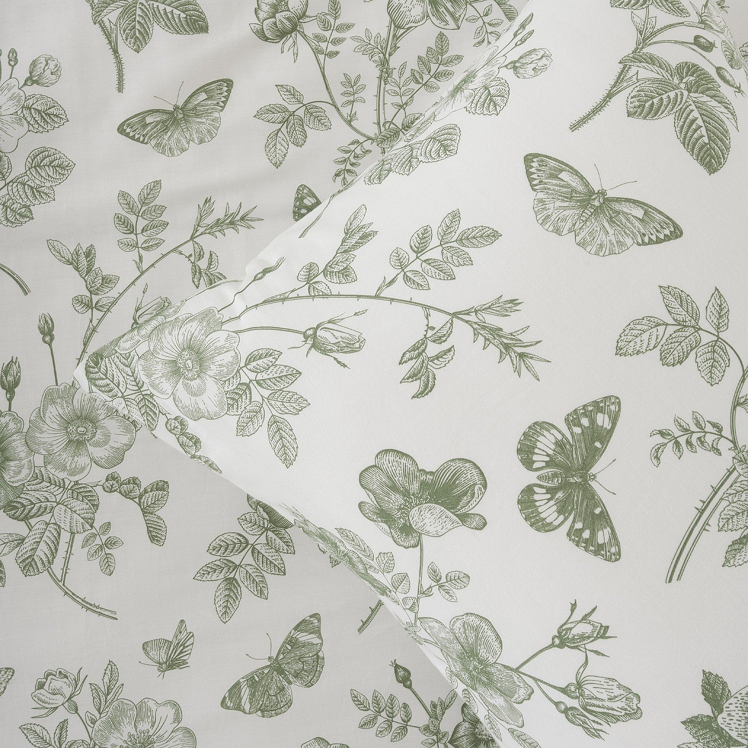 Fabric with green floral and butterfly pattern on a light gray background