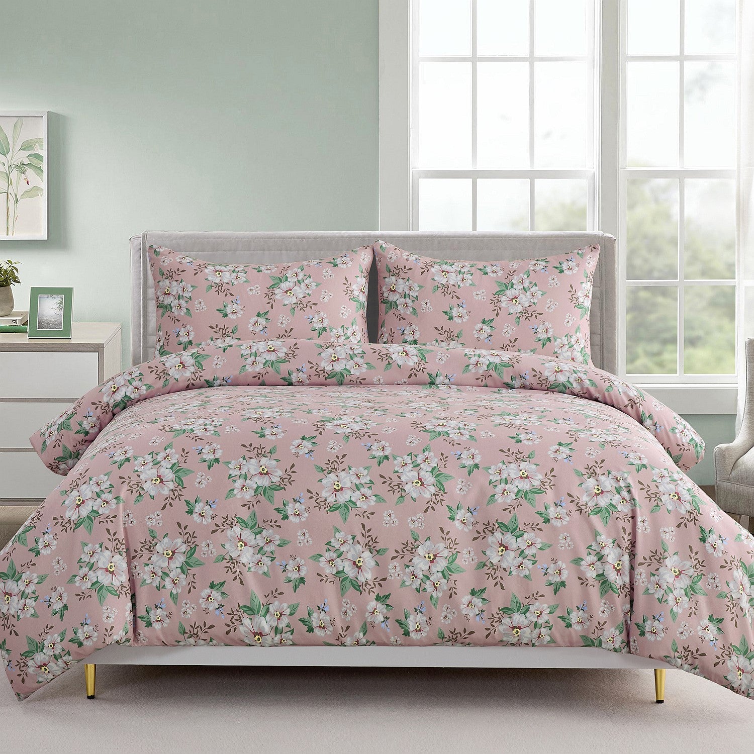 Floral bedding set on a bed in a bedroom with a window in the background.