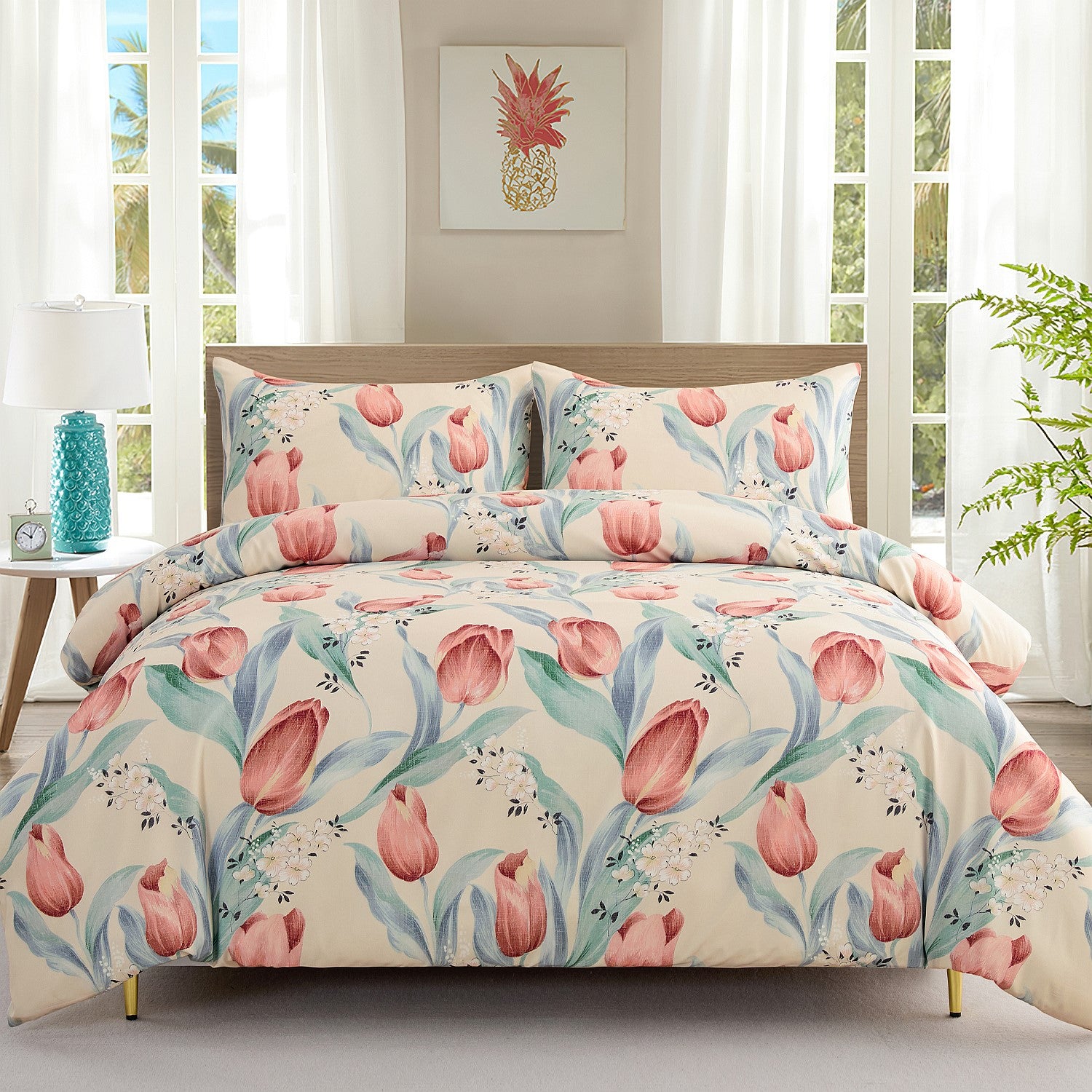 Floral bedding set on a bed in a bright bedroom with large windows.