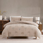 Beige patterned comforter set on a bed in a bedroom setting with neutral decor.
