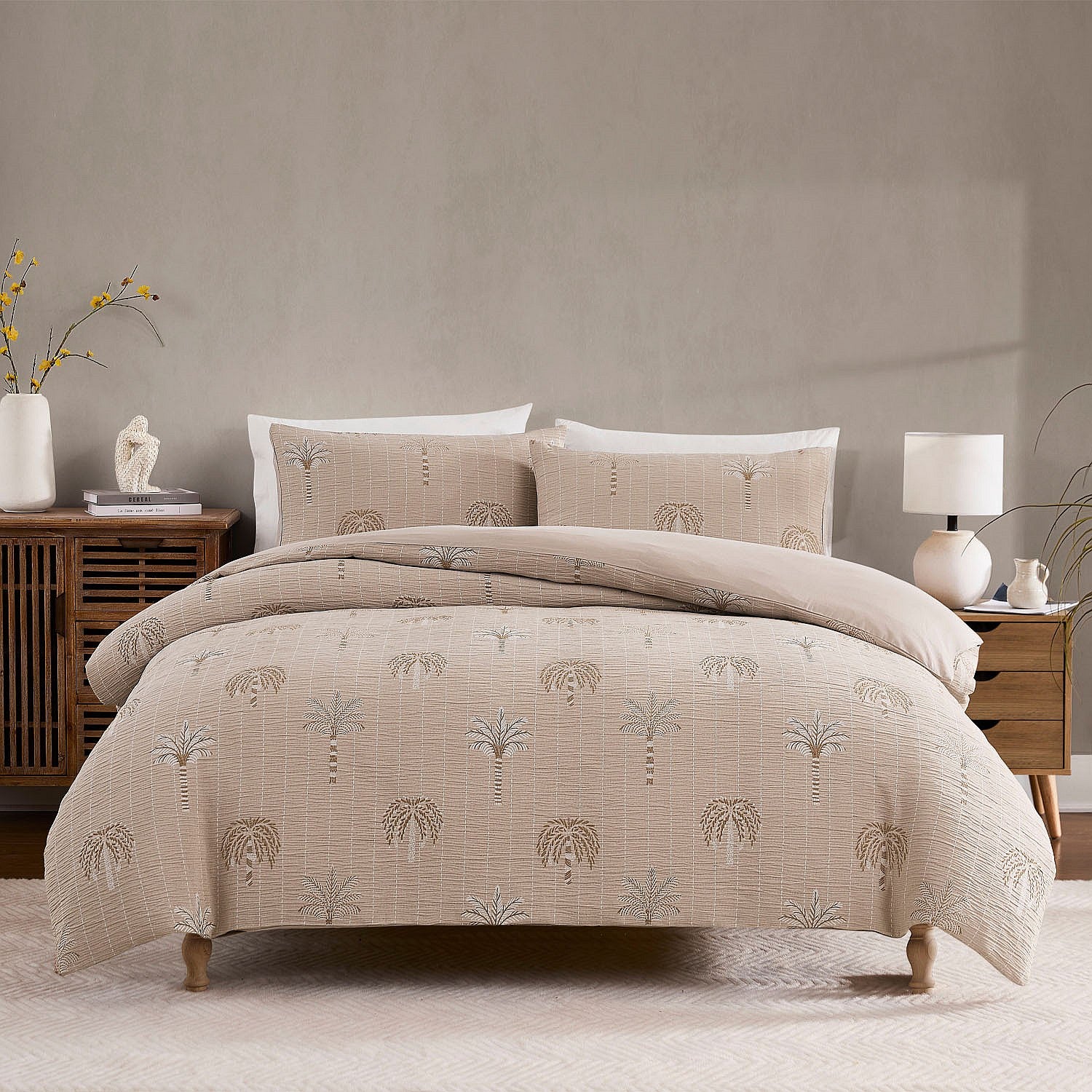 Beige patterned comforter set on a bed in a bedroom setting with neutral decor.