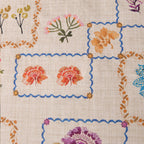 Decorative fabric with floral patterns and blue borders on a beige background