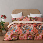Bed with floral and animal patterned bedding in a room setting.