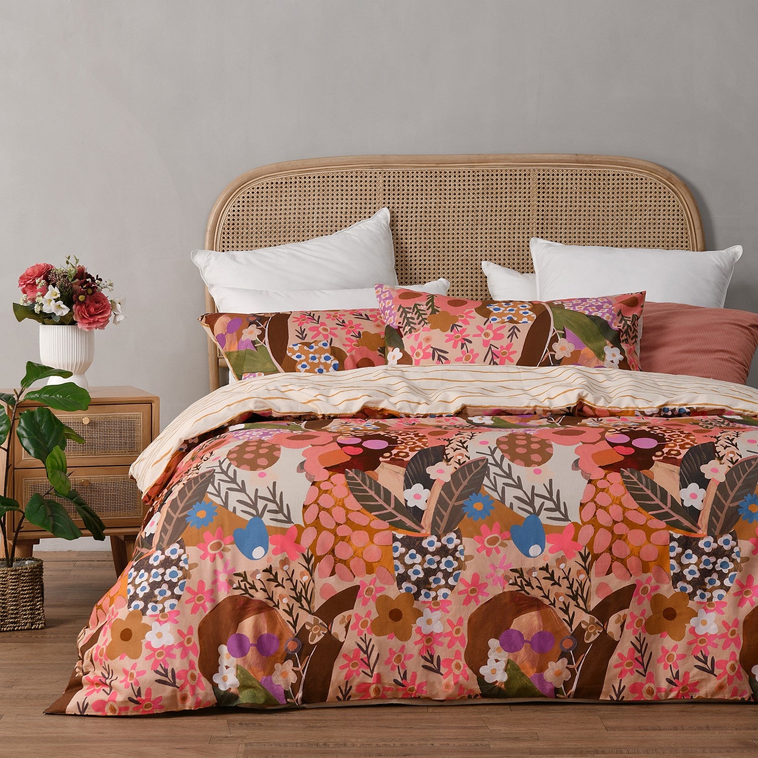 Bed with floral and animal patterned bedding in a room setting.