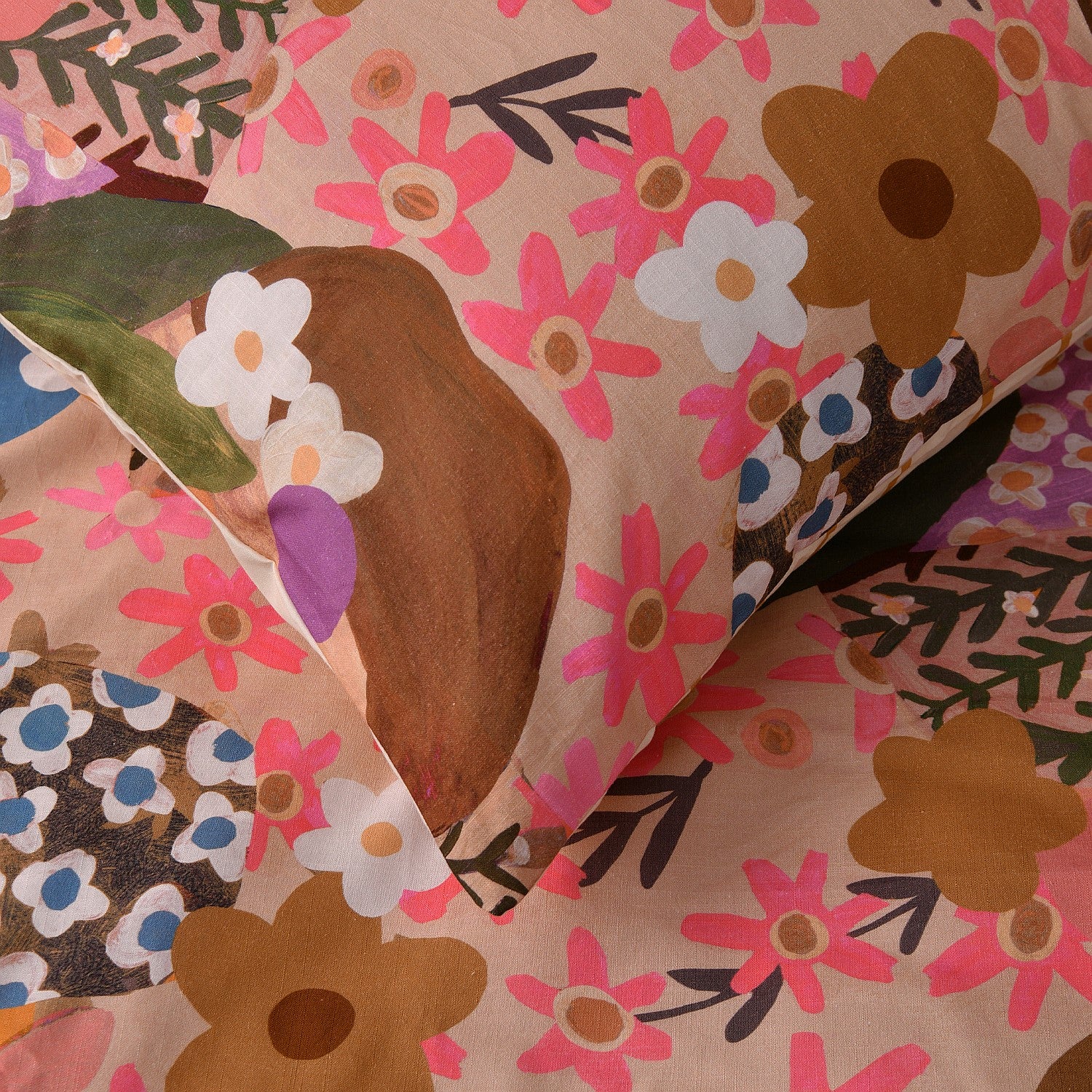 Close-up of floral-patterned fabric with pink, brown, and green colors.