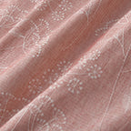 Close-up of pink fabric with white floral embroidery