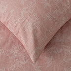 Pink fabric with subtle white floral pattern
