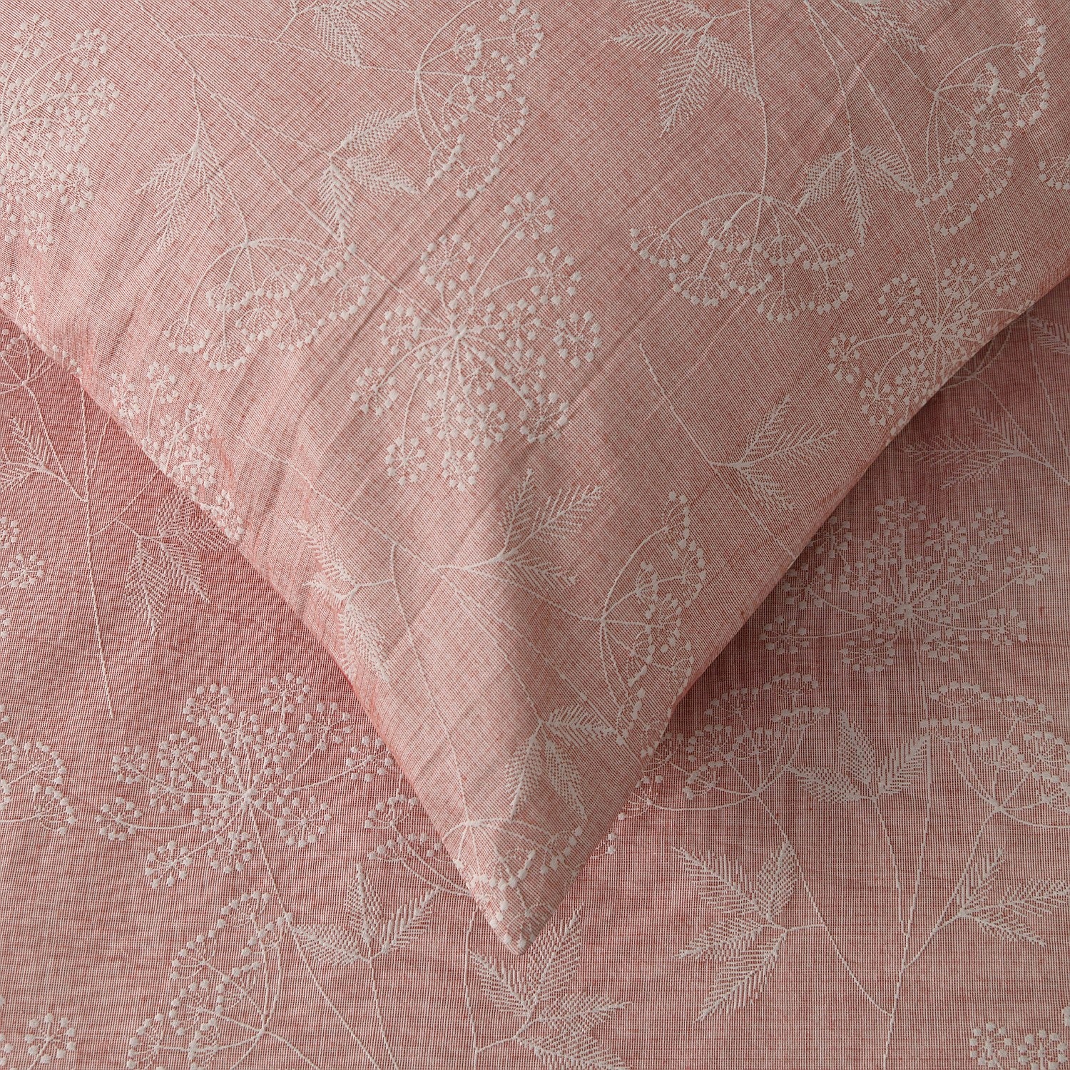 Pink fabric with subtle white floral pattern