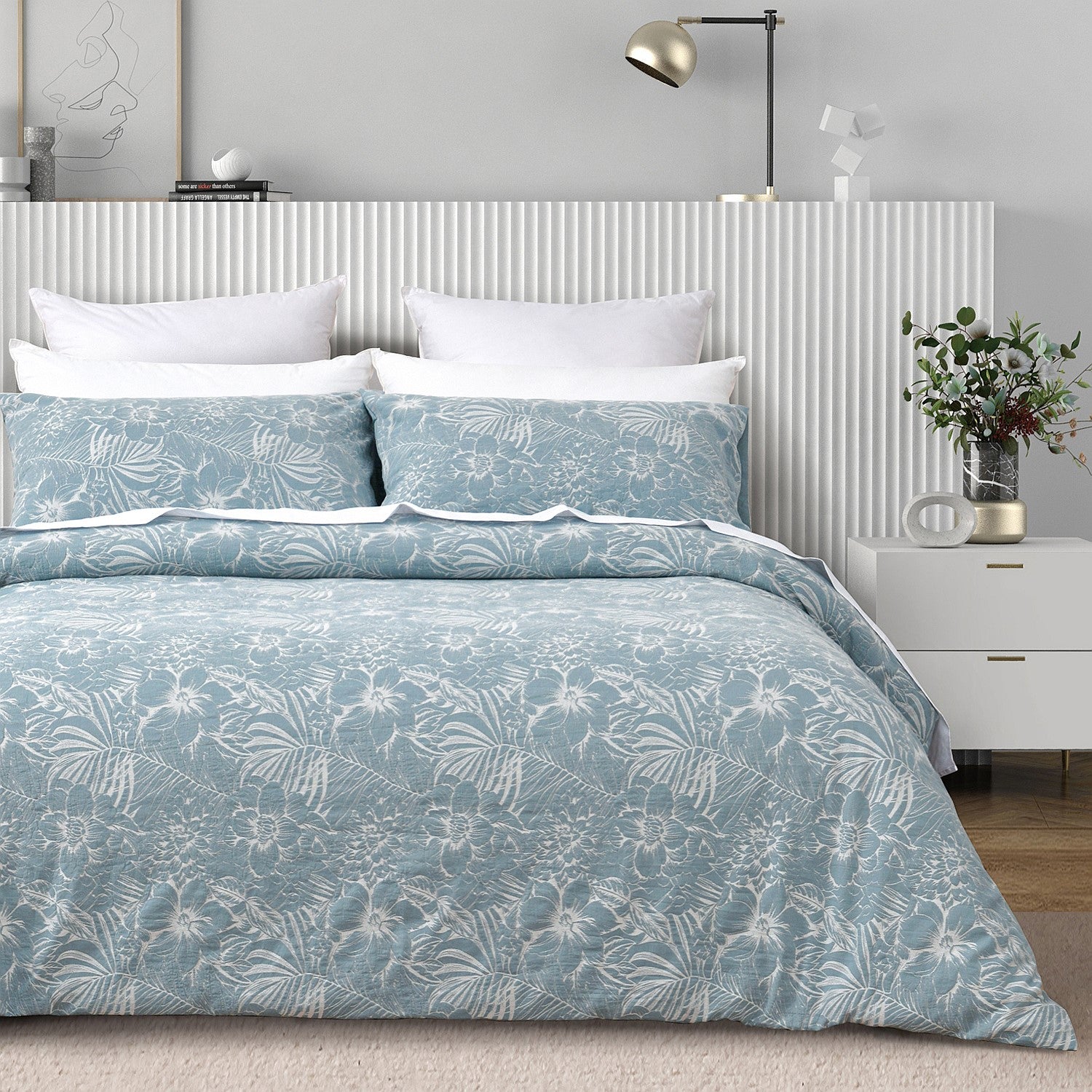 Bed with blue floral bedding in a bedroom setting