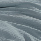 Close-up of textured blue fabric with folds