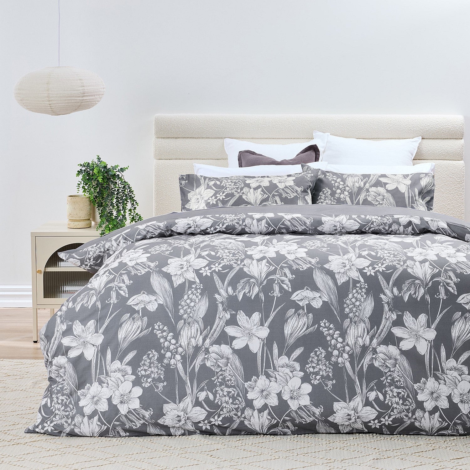 Bed with floral patterned bedding in a bedroom setting