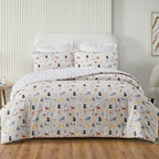 Bed with dog-patterned bedding in a bedroom setting
