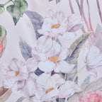 Close-up of a floral pattern with white flowers and green leaves on a light background