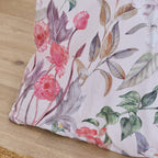 Floral-patterned pillow on a wooden surface