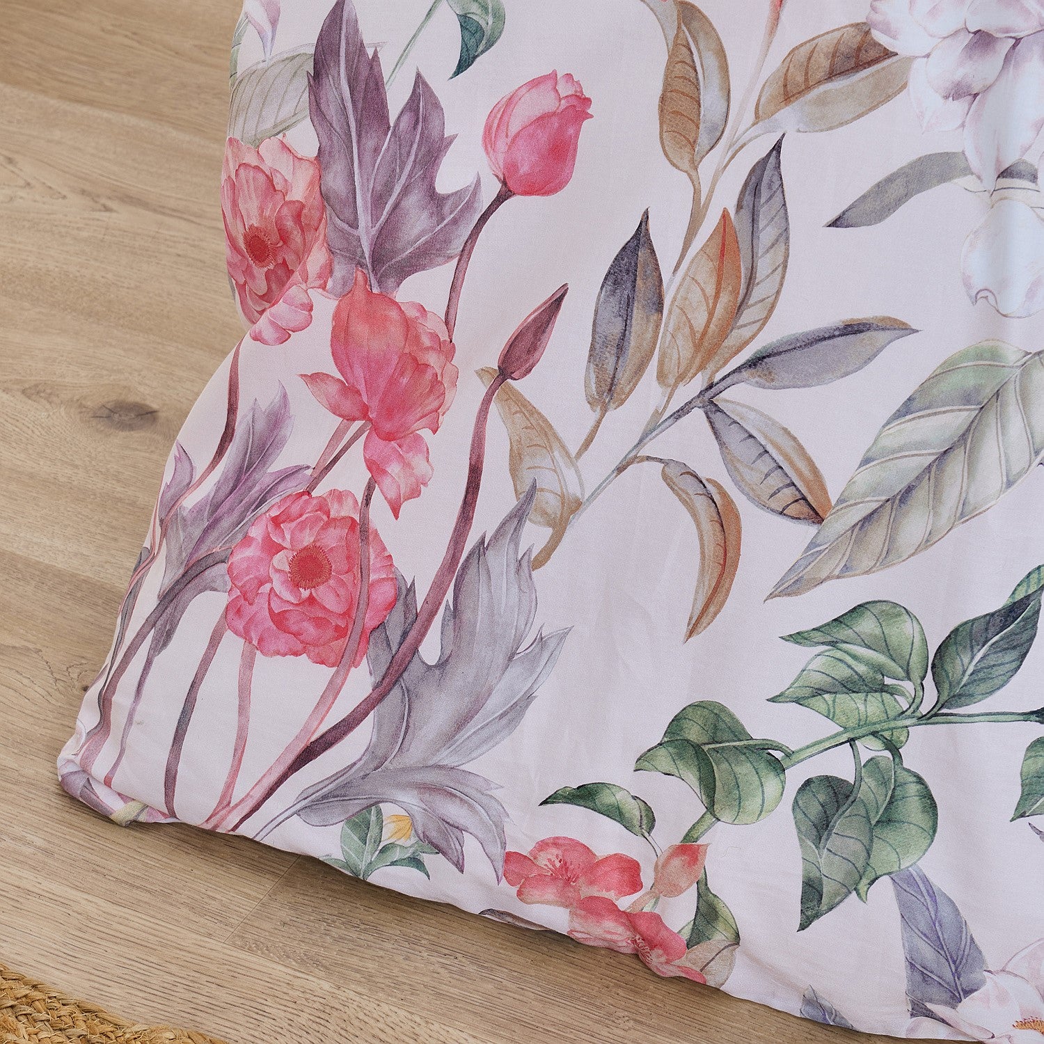 Floral-patterned pillow on a wooden surface