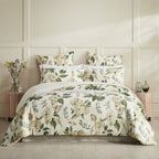 Floral bedding set on a bed with matching pillows in a bedroom setting.