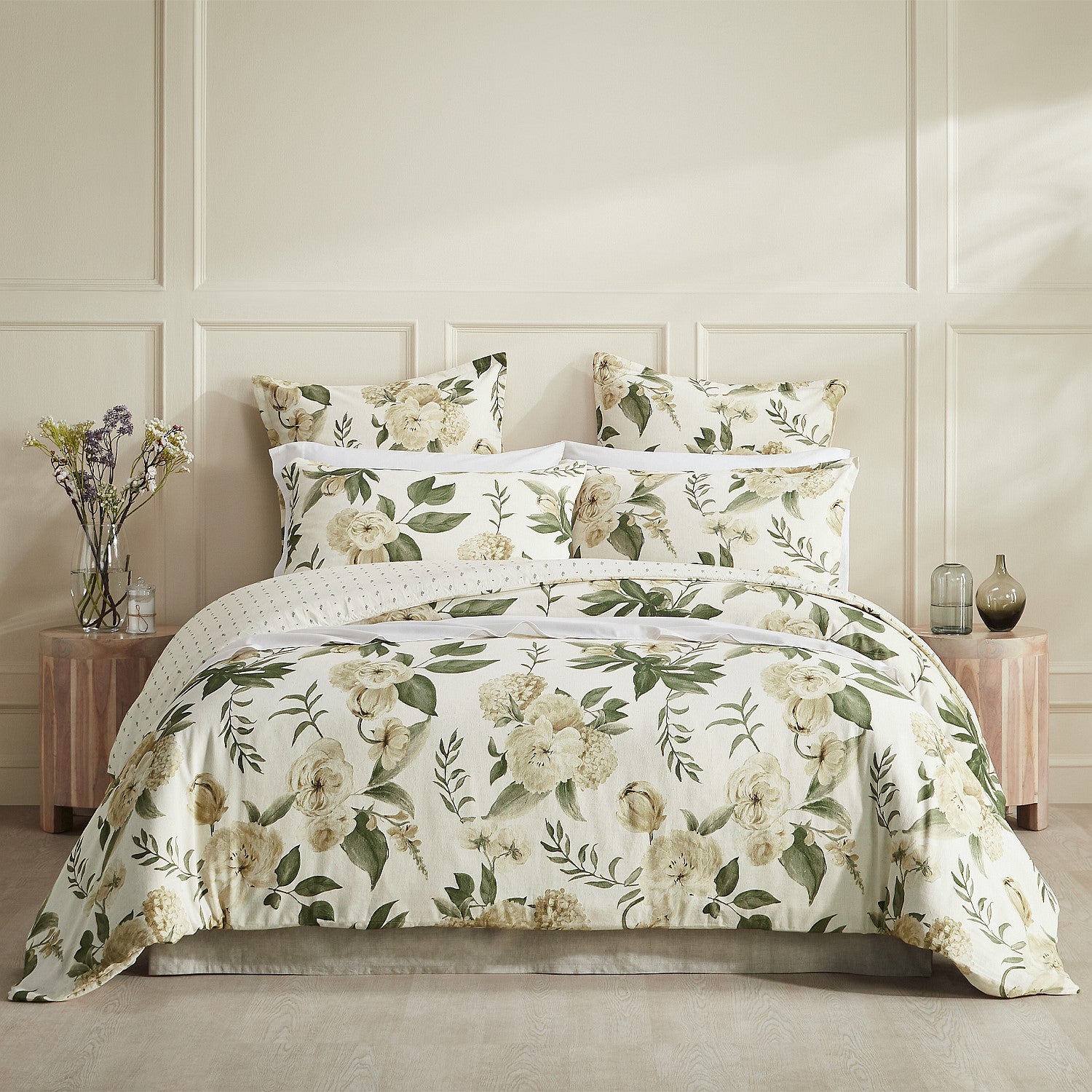 Floral bedding set on a bed with matching pillows in a bedroom setting.