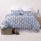 Kids football print duvet cover set styled on a white bed in a neutral bedroom.