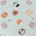Pattern of cartoon animal faces on a light blue background