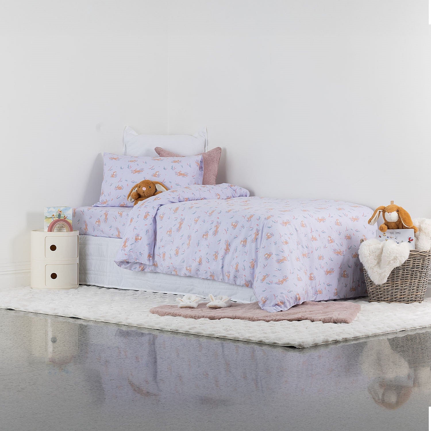 Kids purple duvet cover set styled on a white bed in a neutral bedroom.