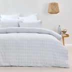 Bed with checkered duvet cover in a bedroom setting