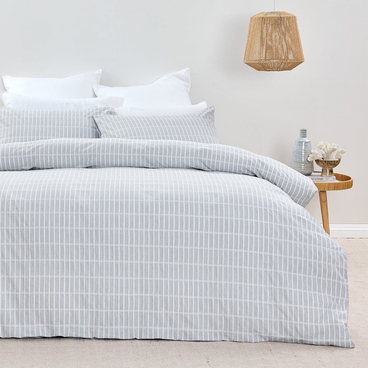 Bed with checkered duvet cover in a bedroom setting