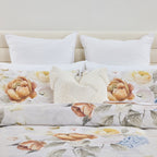 Floral bedding set with white pillows on a neutral background