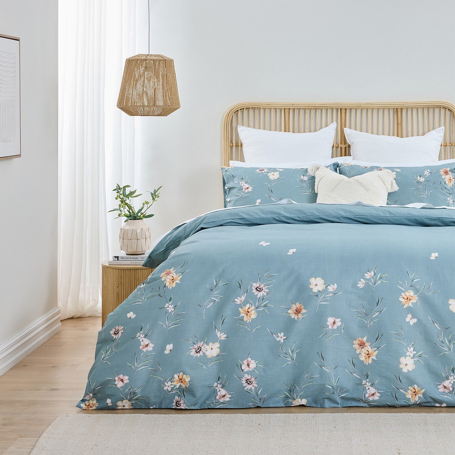 Bed with floral bedding in a bright bedroom setting