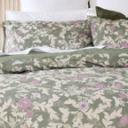 Floral patterned bedding set on a bed with white pillows.