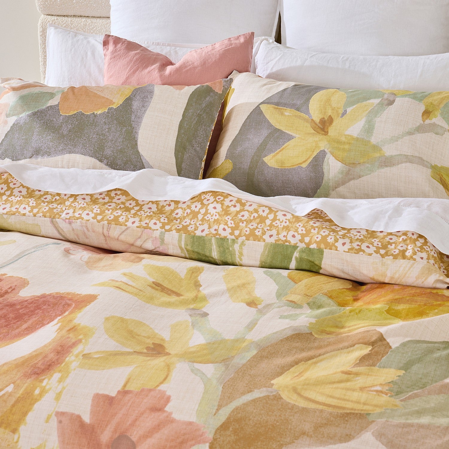 Floral patterned bedding with colorful flowers on a bed.