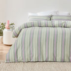 Green and purple striped duvet cover set on a bed with a neutral background