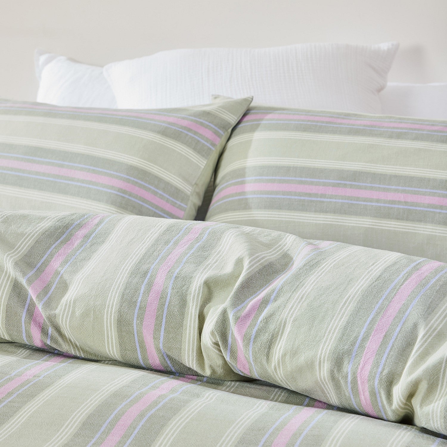 Striped bedspread with pink and blue lines on a neutral background
