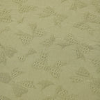 Textured green fabric with geometric pattern