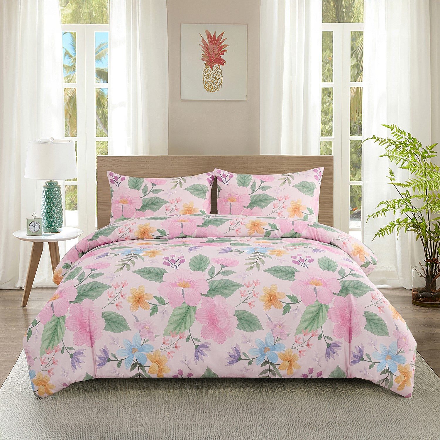 Floral comforter set on a bed in a bright bedroom with a pineapple artwork on the wall.