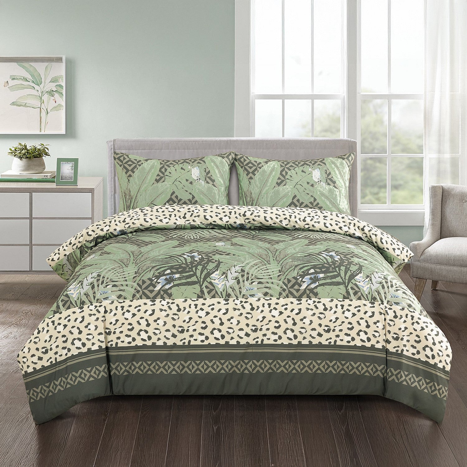Green and white floral patterned comforter set on a bed in a bedroom.